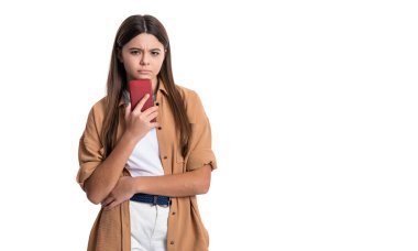 photo of serious teen girl blogging on phone blog. teen girl blogging in blog isolated on white background. teen girl blogging on blog. teen girl has blog for blogging in studio.
