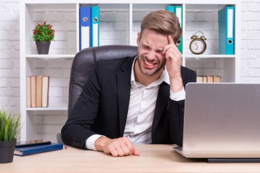 stressed businessman has headache on background. photo of stressed businessman has headache. stressed businessman has headache isolated on white. stressed businessman has headache in office