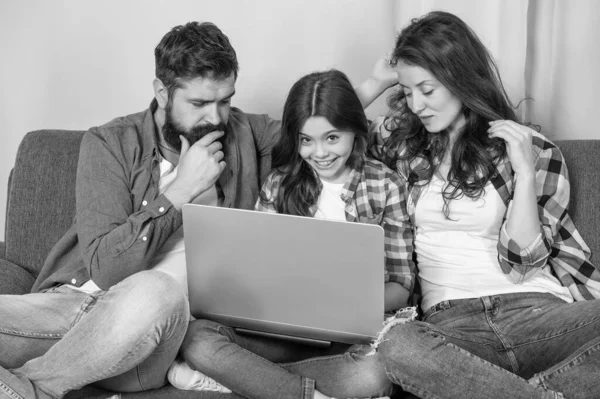 mom dad and daughter shopping on cyber monday. modern education and communication. video call. father mother and child use pc. family blog. happy parents with kid girl study online.