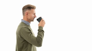 man drinking coffee isolated on white with copy space. man drinking coffee in studio. man drinking coffee on background. photo of man drinking coffee.