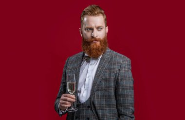 tuxedo man cheering and celebrate isolated on red. tuxedo man cheering and celebrate in studio. tuxedo man cheering and celebrate on background. photo of tuxedo man cheering and celebrate.