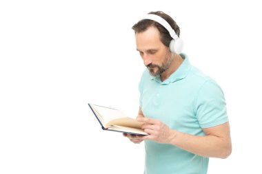 man reading elearning in headphones, advertisement. photo of man reading elearning in headphones. man reading elearning in headphones isolated on white. man reading elearning in headphones in studio.