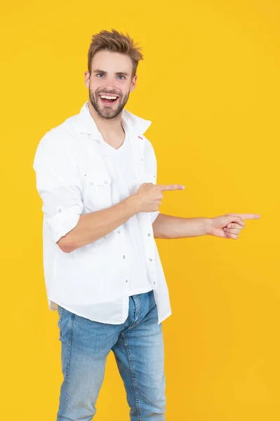 handsome man with stubble on background, pointing finger. photo of handsome man with stubble hair. handsome man with stubble isolated on yellow. handsome man with stubble in studio.