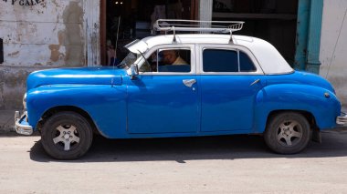 Havana, Cuba - May 02, 2019: classic old timer car pontiac with driver man.