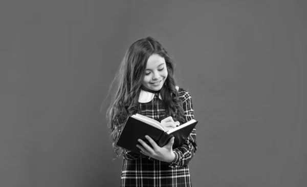 back to school. childhood education. making notes. smiling pupil or student hold notebook. teen girl study with book. child holding copybooks. concept of knowledge and wisdom.