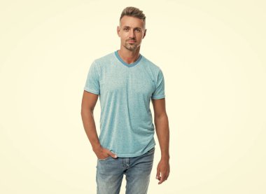 Ciddi, orta yaşlı, orta yaşlı, sıradan bir adam. Elini cebine sokup, beyazları soyutluyor..