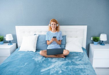 glad girl chat on phone. girl with phone chat at home. phone chat of girl in headphones.