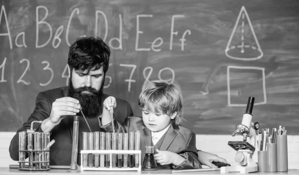 father and son at school. teacher man with little boy. Back to school. Little kid learning chemistry in school laboratory. school kid scientist studying science. Its Your World. Take Control.