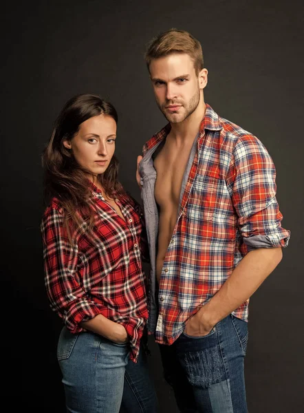sexy couple in love on black background. young people. man and woman. guy and girl together in checkered shirt. togetherness. concept of romantic relationship. fashion and beauty.