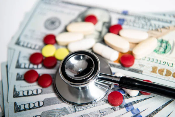 photo of stethoscope and medicine finance money. medicine finance concept. money for medicine finance in closeup and selective focus. medicine finance in studio.