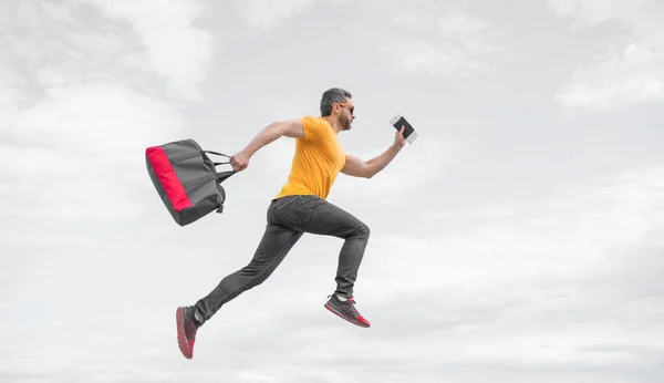 Energetic Guy Running Travel Bag Midair Sky Background Vacation — Φωτογραφία Αρχείου