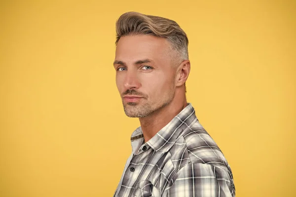 mature man with hoary hair on yellow background.