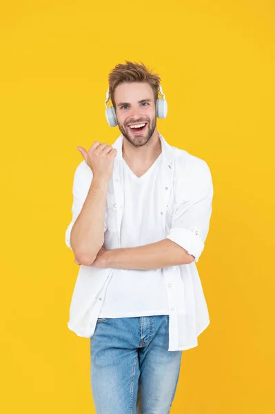 man wear music headphones on background. photo of man wear music headphones. man wear music headphones isolated on white. man wear music headphones in studio.