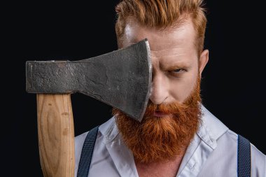caucasian brutal man with ax in studio. brutal man with ax on background. photo of brutal man with ax. brutal man with ax isolated on black.