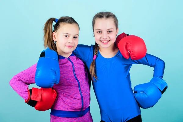 Everything is possible. Happy children sportsman in boxing gloves. workout of small girls boxer in sportswear. punching knockout. Childhood activity. Fitness diet. energy . Sport success. Friendship.