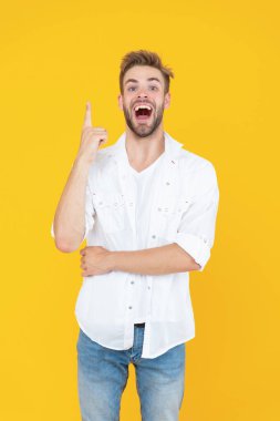 amazed handsome man with stubble in studio. handsome man with stubble on background. photo of handsome man with stubble hair. handsome man with stubble isolated on yellow.