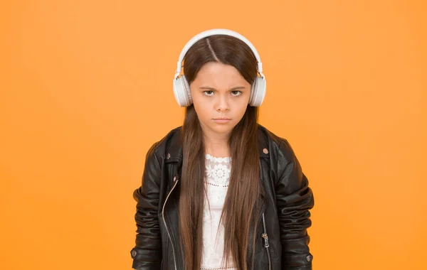 Perception of sounds. Learning lyrics. Music trends shaping future. Musical taste. Musical accessory. Gadget shop. Small girl listening music wireless headphones. Stereo sound. Musical education.