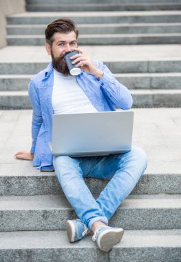 communication of cheerful freelancer man outside. freelancer man has communication at coffee break. freelancer man has communication on laptop. freelancer man has communication on pc outdoor.
