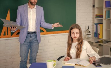 Çocuk öğretmenle aynı sınıfta okuyor. seçici odak.