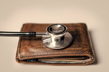 closeup of stethoscope and wallet as symbol of medical insurance. life planning and medical insurance. medical insurance concept.