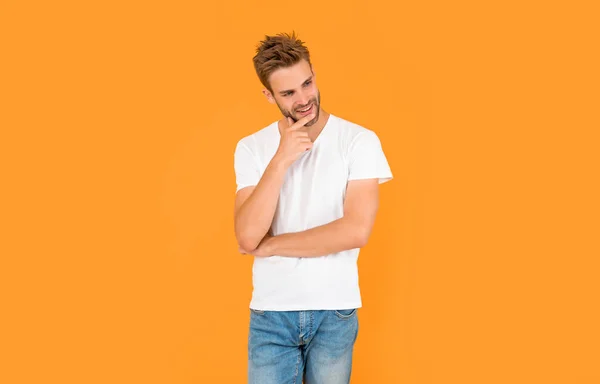hair and beard care. confident and handsome unshaven guy. male casual fashion. mens beauty. man with bristle in white shirt. cheerful young man on yellow background.