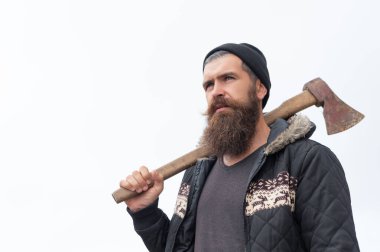 bearded man lumberjack has axe, copy space. bearded man lumberjack with axe. photo of bearded man lumberjack holding axe in the mountain. bearded man lumberjack hold axe outdoor.