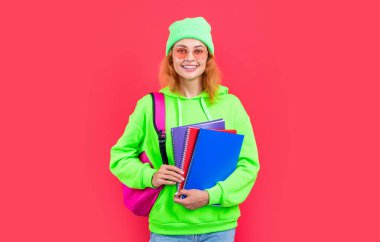 school education of cheerful girl student. school girl student isolated on red background. school girl student at studio. photo of school girl student hold backpack.