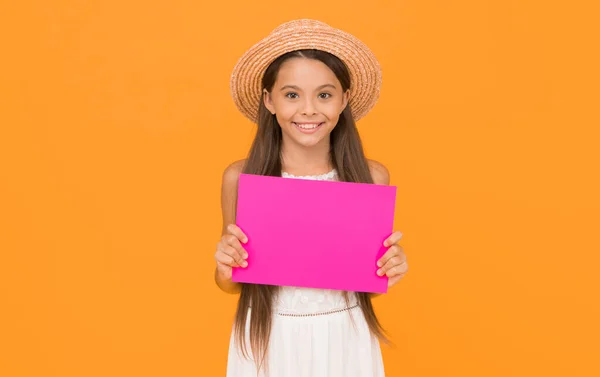 just look here. happy childrens day. paper sheet for copy space. summer activity in camp. vacation announcement for kid. small girl wear straw beach hat. fashion and beauty. childhood happiness.