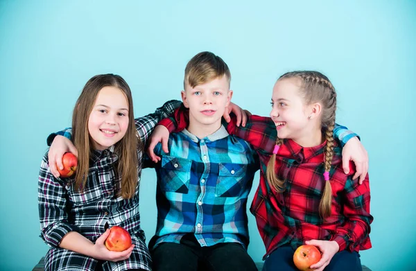 Think healthy first. Small group of children enjoy healthy eating together. Little children holding red apples. Cute children with healthy apple snack. Healthy children.