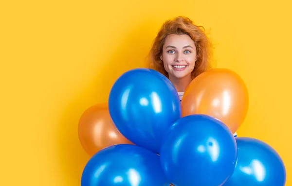 happy birthday woman hold balloons in studio. happy woman with balloon for birthday party isolated on yellow background. birthday party woman.