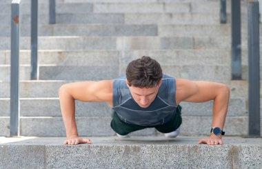 image of athlete man do pushups in sportswear. athlete man do pushups outdoor.athlete man do pushups outside. athlete man do pushups in the street.