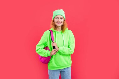 photo of glad school woman education hold backpack. school education of woman student. school woman education isolated on red background. school woman education at studio.