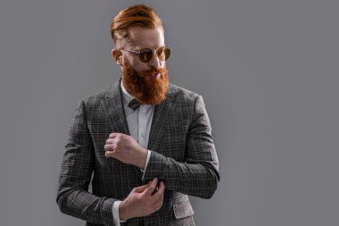 redhead tuxedo formal man isolated on grey. tuxedo formal man in studio. tuxedo formal man on background. photo of tuxedo formal man with beard.