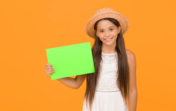 Lets have fun. smiling kid in straw hat. little child advertises beach activity. happy childhood. summer holiday and vacation. kid seasonal fashion sales. carefree beauty show paper sheet. copy space.