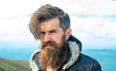 portrait of bearded man outdoor. bearded man has beard. bearded man having moustache. photo of bearded man in the mountain.