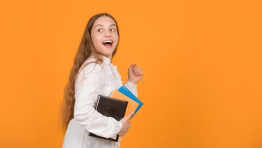 Okul ödevi yapan, sarı arka planlı, fotokopi alanı ve çocukluğu olan mutlu koşucu çocuk..