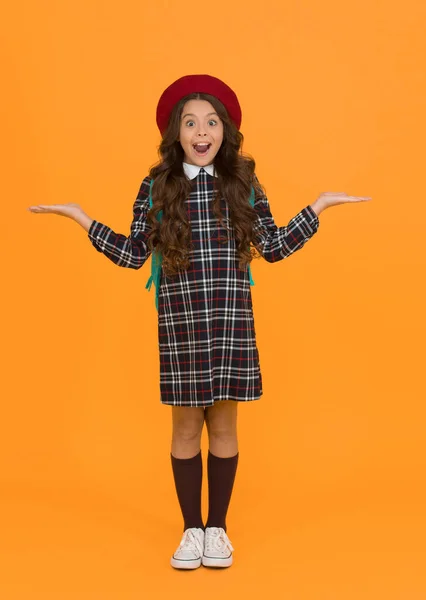 what a surprise. education. knowledge day. happy childhood. french style concept. back to school. retro girl wear uniform and parisian beret. kid school fashion. surprised child ready for schoolyear.