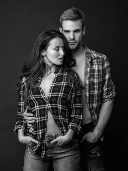 sexy man and woman standing together in checkered shirt, love.
