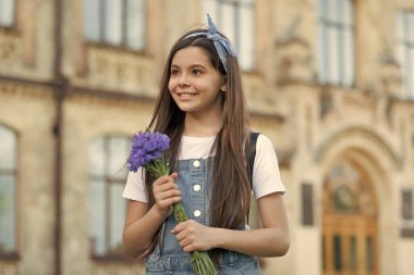 smiling girl with spring flowers on womens day.