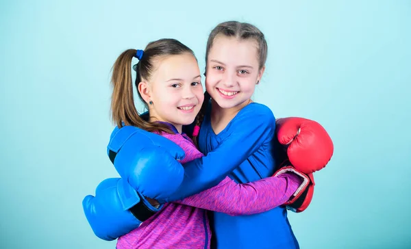 Sport success. Friendship. workout of small girls boxer in sportswear. punching knockout. Fitness diet. energy health. Happy children sportsman in boxing gloves. Training their boxing skills.