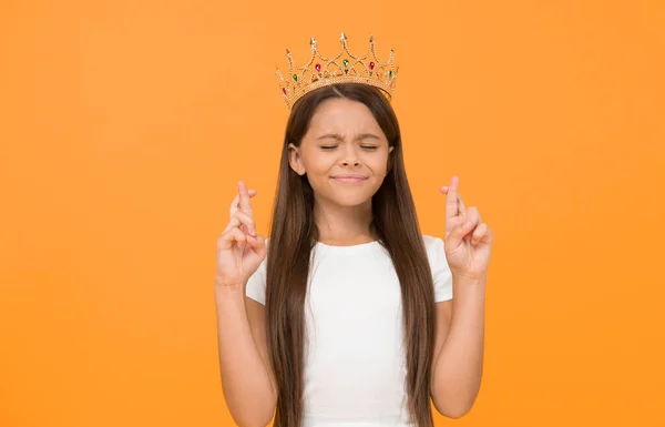 make a wish. dreams come true. symbol of bright future. small child winner. girl is proud if herself. childhood happiness. big boss is in. share her success. selfish little girl with gold crown.