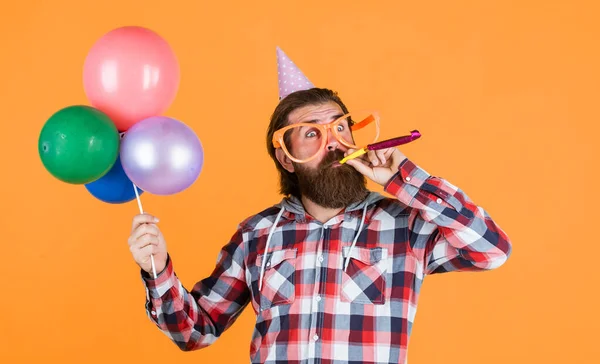 Great day for shopping. best party for retirement. cheerful man with beard and moustache. hipster smiling with balloon. Celebrating happy party. Party Elements and holiday objects. Multi colored fun.