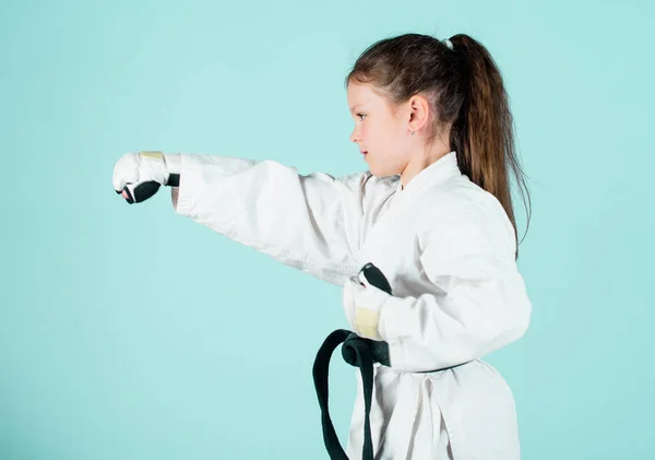 sport success in single combat. practicing Kung Fu. happy childhood. little girl in gi sportswear. small girl in martial arts uniform. knockout. energy and activity for kids. Free your mind.