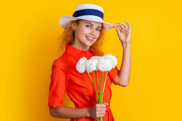 retro girl with mothers day flowers isolated on yellow. girl with mothers day flowers in studio. girl with mothers day flowers on background. photo of girl with mothers day chrysanthemum flowers.