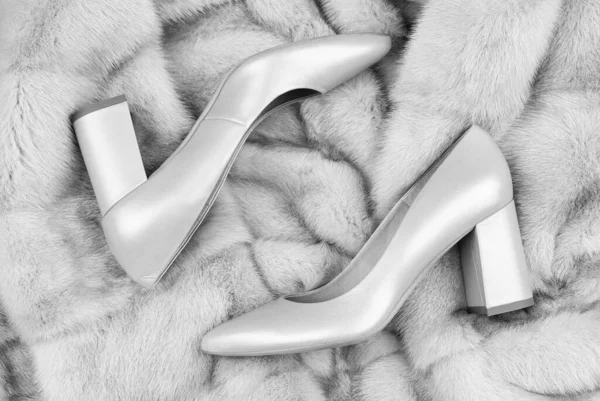 stock image stylish leather shoes on fur background, high heel.