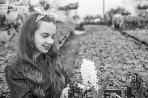 earth day. child gardener. flowers in garden. daily chores. flower care. horticulture. gardening activity for kid. happy teen girl florist in greenhouse. spring and summer. planting pot plants.