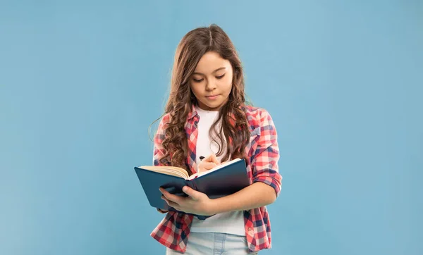 busy pupil or student hold notebook. teen girl study with book. child holding copybooks. concept of knowledge and wisdom. back to school. childhood education. making notes.