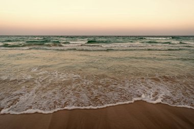 summer beach with sea water waves and sky horizon.