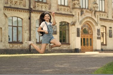 positive teen kid jump. energetic teen girl jump outdoor. free teen child jump.