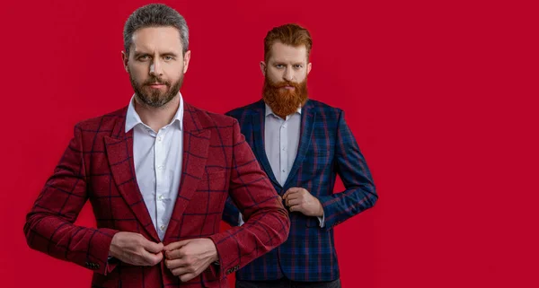 photo of formal elegant men in formalwear, copy space. formal elegant men isolated on red. formal elegant men at studio. formal elegant men on background.